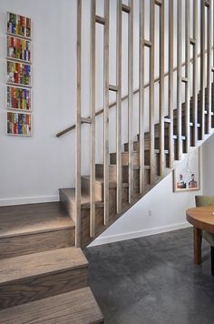 there is a wooden stair case next to the table