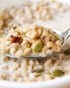 a spoon filled with oatmeal and nuts