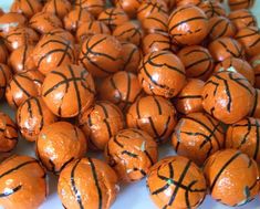 basketball balls are sitting on top of each other in a pile and have black lines painted on them