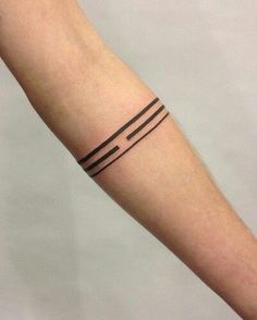 a person with a tattoo on their arm that has lines in the middle and one line at the top