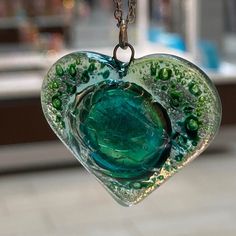 Heart shaped recycled fused glass pendant. Color: green All the jewelry is handmade out of recycled glass. This is real glass that comes from windows and other more traditional sources. The glass is cut and assembled, then fired in a kiln to fuse round sharp edges and improve the colors and texture of the surface. When the glass fuses, each design becomes a unique creation due to the vitro-fusion process. "Eco-friendly jewelry" at its finest! The bead is apprx 1 inch each side, The charm is abou Green Pendant Necklace For Keepsake, Green Pendant Necklace As Keepsake, Green Handmade Necklace For Keepsake, Green Recycled Glass Pendant Jewelry, Green Resin Round Pendant Necklace, Green Recycled Glass Necklaces For Jewelry Making, Green Glass Pendant Jewelry, Handmade Green Recycled Glass Jewelry, Handmade Green Jewelry From Recycled Glass