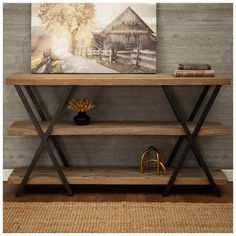 a wooden table with two shelves and a painting on it's wall behind it