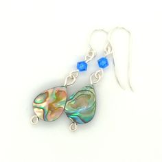 Elevate any look with my elegant Sterling Silver Abalone Dangle Earrings. Featuring a spinning abalone teardrop bead and a dark teal crystal accent, these ladies earrings are sure to impress. Choose from a large or small shell drop style to match your unique style. Abalone Shells - A sacred symbol of the sea. They help strengthen love within, foster interpersonal harmony, release negative feelings and ease stressful situations. Iridescent Dangle Earrings Nickel Free, Elegant Iridescent Hypoallergenic Jewelry, Teardrop Beaded Earrings For Gift, Pierced Teardrop Beaded Earrings As Gift, Pierced Teardrop Beaded Earrings For Gift, Elegant Teardrop Sterling Silver Beaded Earrings, Elegant Iridescent Beaded Earrings For Gift, Elegant Hypoallergenic Teardrop Beaded Earrings, Pierced Teardrop Pearl Earrings