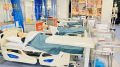 a hospital room with beds and medical equipment