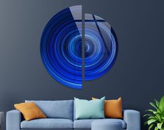 a living room with a blue couch and large circular painting on the wall