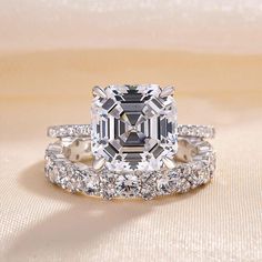 an engagement ring with a large diamond surrounded by smaller diamonds