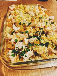 a casserole dish with chicken and vegetables in it on a wooden table top