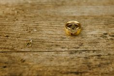 a gold ring sitting on top of a wooden table