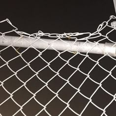 a close up of a metal fence with chain link