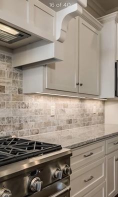 a kitchen with white cabinets and an oven