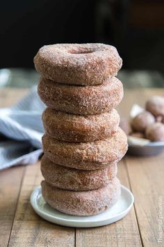 a stack of doughnuts sitting on top of a white plate