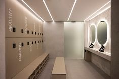 an empty locker room with several sinks and mirrors on the wall next to each other