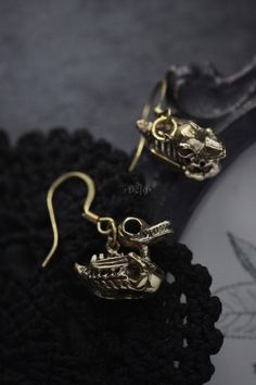 Cool duck skeleton earrings Nice handmade details on skeleton. One of our unique duck skeletons collections by Defy. - The duck dimensions are ; 1.5 x 0.9 cm. - New earring wires. - Material : brass / silver **Free Shipping to World Wide** - Please allow us to prepare the item and parcel between 3-5 working days (*Between 5-7 working days For Sterling Silver 925*) - All items will be sent by Thai Registered Airmail. The delivery usually takes about 2-4 weeks for parcel to arrive in most countrie Steampunk Skull Jewelry Gift, Steampunk Gold Jewelry For Halloween, Handmade Gothic Gold Earrings, Gold Gothic Earrings As Gift, Handmade Steampunk Gold Earrings, Handmade Gold Steampunk Earrings, Skull Shaped Metal Earrings For Gifts, Gothic Gold Brass Earrings, Gold Gothic Brass Earrings