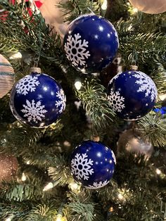 blue and white ornaments hanging from a christmas tree