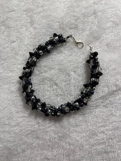 Woven black and sliver chunky, woven glass beaded bracelet. Handmade Metal Braided Bracelets In Black, Handmade Black Metal Braided Bracelets, Party Metal Beaded Bracelets With Black Beads, Black Beaded Braided Bracelet, Black Faceted Beads Crystal Bracelet For Party, Black Crystal Bracelet With Faceted Beads For Party, Silver Crystal Bracelet With Black Beads For Party, Black Beaded Metal Bracelets, Black Metal Bracelet With Silver Beads