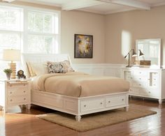 a bedroom with a bed, dressers and two night stands on the hardwood floor