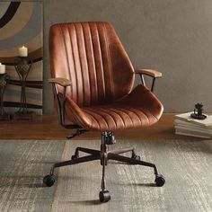 a brown office chair sitting on top of a wooden floor next to a table and lamp