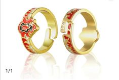 two gold rings with red and white designs on them