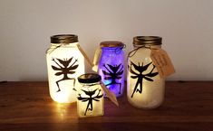 three mason jars with dragonflies painted on them