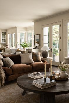 a living room filled with furniture and lots of windows