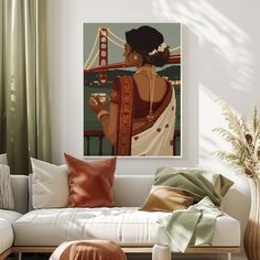 a living room filled with furniture and a painting hanging on the wall above a white couch