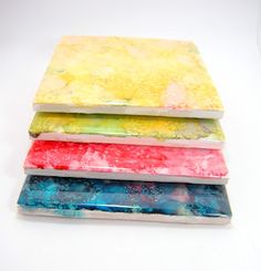 four different colored papers stacked on top of each other