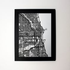 a black and white photo of a city map in a frame with the words chicago on it