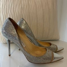 Women's Jimmy Choo Glittered Woven Pumps - Metallic Pumps Woven Glittered Pointed Toe Slip On Leather Sole Made In Italy. 100% Leather. Silver Heel. *Dust Bag Not Included. 100% Authentic. Condition: Gently Loved - Light Creasing And Wear Throughout Insoles. . Please Note: Jimmy Choo Shoes Typically Run 1 To 1 1/2 Sizes Smaller. All Sizing Is Dependent Of Shoe Style. Material: Lame, Metallic Leather Origin: Italy Hardware: Silver Plated Toe: Closed Heel Style: Stiletto Shoe Width: Regular Luxury Glitter Heels With Round Toe, Designer Sparkling Heels With Pointed Toe, Designer Sparkling High Heels, Silver Heel, Metallic Pumps, Stiletto Shoes, Silver Heels, Jimmy Choo Shoes, Shoes Color