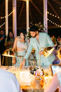 a man and woman cutting a cake together