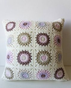 a crocheted pillow with flowers on it