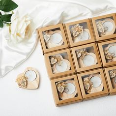 six wooden coasters with carved hearts and flowers in them next to a white rose