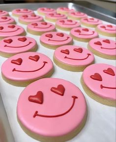 pink decorated cookies with hearts and smiling faces