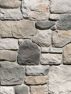 a stone wall that is made out of different types of rocks