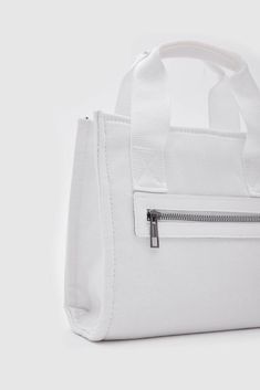 Introducing the "Canvas Fabric White Crossbody Bag" from Lunarity Garage – a chic and versatile accessory that combines the durability of canvas fabric with the timeless elegance of white. Crafted with meticulous attention to detail, this bag offers both fashion and functionality to suit your everyday needs. Elevate your style with the Canvas Fabric White Crossbody Bag – a perfect blend of durability and sophistication. The pristine white color adds a touch of refinement, making it a versatile a Best Crossbody Bags, White Crossbody Bag, Running Errands, White Color, Canvas Fabric, Silver Color, Timeless Elegance, Crossbody Bag, Garage