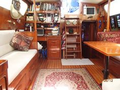 the inside of a boat with wood floors and furniture