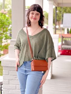 The Kailani Top is an oversized, but comfortable top that can be easily paired with any type of bottoms! This top is perfect for lounging at home, or running your daily errands. Pair this top with leggings and boots, or jeans and casual sneakers for your everyday, go-to outfit. Item Details: Short Sleeves V-Neck High-Low Length Oversized Side Slits Detail Fabric Content: 100% Cotton Fit Details: Sierra is wearing a size medium. We find that the Kailani Top runs oversized, if you are wanting a mo Comfortable Tops For Everyday Fall Wear, Comfortable Everyday Tops For Fall, Comfortable Brown Tops For Everyday, Casual Brown Tops For Layering, Comfortable Casual Tops For Everyday, Comfortable Tops For Everyday Spring Wear, Comfortable Brown Tops For Fall, Versatile Fall Tops For Day Out, Fall Casual Comfortable Tops