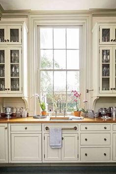 the front cover of home magazine featuring an image of a kitchen with white cabinets and counter tops