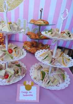 a table topped with plates filled with sandwiches