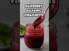 raspberry balsamic vinaigrete is being poured into a jar