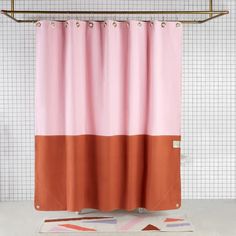 a shower curtain with an orange and pink color block