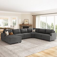 a living room filled with furniture and a large rug on the floor in front of a fireplace