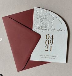 a wedding card with a red envelope and gold numbers