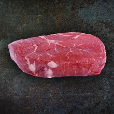 a piece of raw meat sitting on top of a table