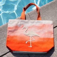 You'll be beach ready with the Maui Water Resistant Tote! Water resistant so your belongings won't get wet, this tote bag features a vibrant coral color with a gorgeous flamingo hand embroidered across the front and inner pockets inside for extra organization, this water resistant bag will be your new summertime staple. This beach bag effortlessly doubles as a cruise bag, sports bag, or overnight bag to store your travel essentials. The perfect vacation bag or "weekend vibes'' bag! This reusable Beach Season Embroidered Tote Bag, Embroidered Tote Bag For Beach Season, Embroidered Rectangular Canvas Beach Bag, Summer Embroidered Beach Bag For Everyday Use, Embroidered Beach Bag For Everyday Summer Use, Embroidered Travel Bags For Beach Season, Summer Embroidered Beach Bag For Beach Season, Embroidered Beach Bag For Travel, Summer Embroidered Beach Bag