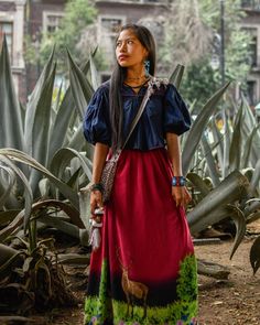 a woman standing in front of some plants