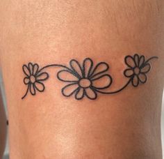 a woman's thigh with flowers tattoo on her left side ribcaulitis