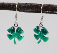 "Sterling silver four leaf clover, shamrock dangle earrings are hand painted with shimmering green epoxy. The earrings are finished with sterling silver French wires.  Add a bit of luck to your day! The shamrocks measure 1/2\" in diameter.  The earrings weigh approximately 2.2 grams Jessica Rose Jewelry is a small handcrafting jewelry company in New Jersey.  We design popular motifs in sterling silver and then add a bit of color to give the jewelry a unique personality. SKU 158" Hypoallergenic Green Enamel Jewelry, Green Dangle Earrings Cadmium-free, Green Cadmium-free Dangle Earrings, Jessica Rose, Silver Sparkle, Rose Jewelry, French Wire, Four Leaf, Everyday Earrings