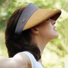 Wide round brim women's visor hat. High front band creates a hat look. Black long bow accent. Wide brim with 4.5" peak, protect face and ears. 2.25" wide band. Elastic comfort closure. UPF 50+ sun protection visor. One size. Upf 50+ Brimmed Visor, Casual Wide Brim Visor With Uv Protection, Brown Baseball Cap For Beach In Spring, Casual Visor With Curved Brim, Casual Curved Brim Visor, Casual Short Brim Visor With Uv Protection, Casual Brimmed Visor One Size Fits Most, Casual Visor With Upf 50+ And Curved Brim, Casual Brimmed Visor