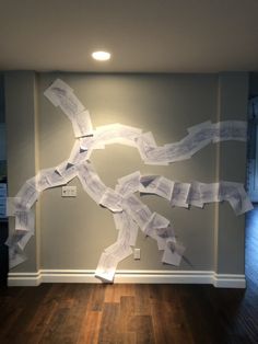 a wall with many pieces of paper taped to it in the shape of a tree