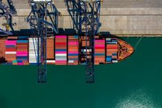 an aerial view of a cargo ship in the water